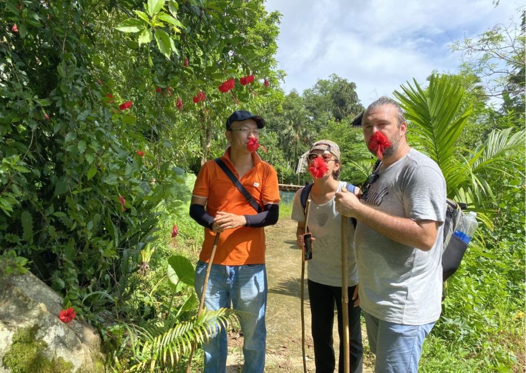 Eco-tourists enjoying a nature walk in a lush tropical garden